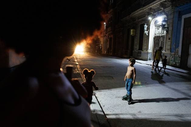 CUBA-HAVANA SOCIAL CRISIS AND WORLD CUP HAVANA, CUBA - JUNE 16, 2026: Residents stand on a pitch-black street corner, illuminated only by the distant headlights of a passing vehicle during a power outage in Central Havana, Cuba, on June 16, 2026. The regular suspension of electrical service paralyzes neighborhood commercial activities and leaves public streets entirely unlit for hours. (Photo by Pablo Miranzo JNA Press via Nexpher Images) HAVANA