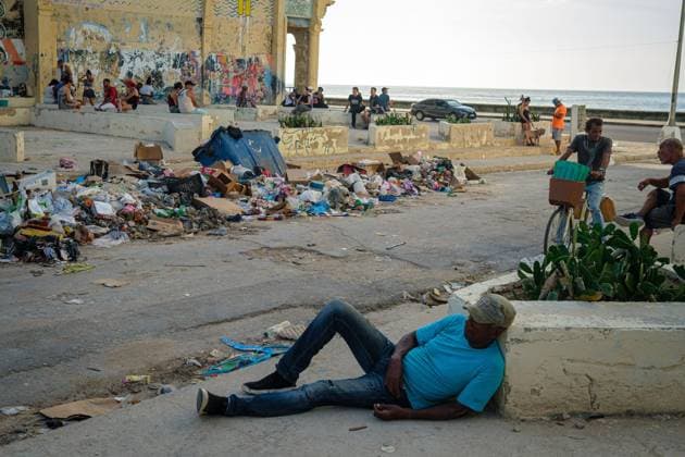 CUBA-HAVANA SOCIAL CRISIS AND WORLD CUP HAVANA, CUBA - JUNE 16, 2026: A man lies stretched out on a concrete ledge next to a street littered with uncollected garbage piles in Havana, Cuba, on June 16, 2026. The visible rise of substance abuse on public pathways intersects with a severe municipal sanitation collapse, heavily impacting the living conditions of the inner city. (Photo by Pablo Miranzo JNA Press via Nexpher Images) HAVANA