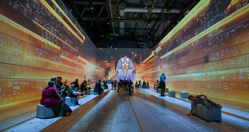Tutankhamun The Immersive Experience, NEC, Birmingham UK Tutankhamun The Immersive Experience arrives at the NEC, Birmingham UK for 12 weeks. Following hugely successful runs in cities such as Madrid, Hamburg, Cairo, Sao Paulo, Barcelona, Vienna, Malmö, London, Glasgow and Stockholm, the groundbreaking 2,000 square metre exhibition invites visitors to step back in time and embark upon an exhilarating journey through ancient Egypt, discovering the myths and mysteries surrounding Pharaoh Tutankhamun. Created in collaboration with Egyptologists and historians, the exhibition features one of Europe™s most expansive immersive video mapping rooms with projections on 8-metre-high surfaces. Blending cutting-edge technology with Egyptian hi  Copyright: xJulesxAnnanx xAvalonx 1110839894