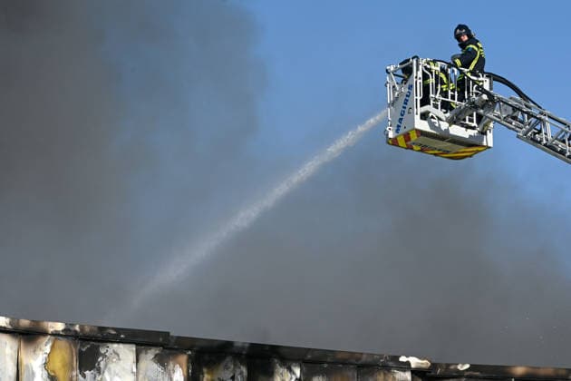 Up to 15 fire crews are working to extinguish a fire at a warehouse in Villaverde, Madrid. A firefighter works to extinguish the fire at a warehouse in Villaverde on June 18, 2026, in Madrid, Spain. Up to 15 fire crews from the Madrid City Council have been working since early this morning to put out a fire at a storage warehouse located on San Mamés Street, in the Villaverde district of Madrid. The fire, which has spread through three of the building’s four facades, has forced the evacuation of a gas station and has produced a large column of smoke visible even from other parts of Madrid and the surrounding area. June 18, 2026, Madrid, Spain,detected_source_language  Copyright: xGustavoxValientex 7605277