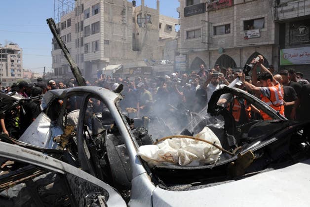 Palestinians Gather at Site of Deadly Vehicle Strike in Gaza City Palestinians and Civil Defense personnel gather around a destroyed vehicle that was targeted in an Israeli airstrike in Gaza City, on June 18, 2026. The strike killed three Palestinians, according to medical sources, and caused significant damage to the vehicle. Photo by Belal Osama apaimages Gaza Gaza Strip Palestinian Territory 180626_Gaza_BO_1_00(22) Copyright: xapaimagesxBelalxOsamax xapaimagesx