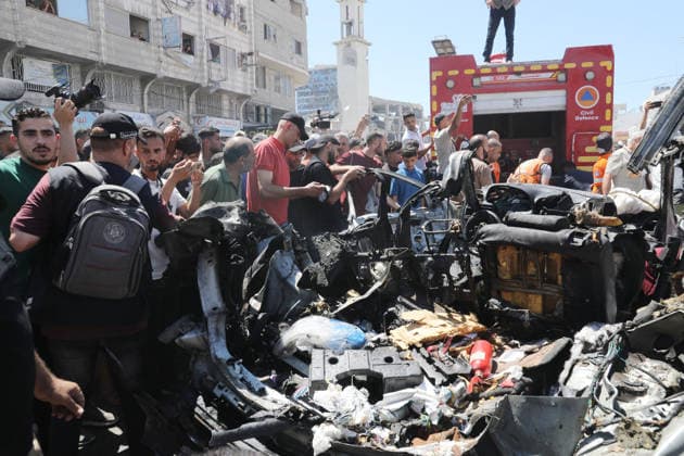Palestinians Gather at Site of Deadly Vehicle Strike in Gaza City Palestinians and Civil Defense personnel gather around a destroyed vehicle that was targeted in an Israeli airstrike in Gaza City, on June 18, 2026. The strike killed three Palestinians, according to medical sources, and caused significant damage to the vehicle. Photo by Belal Osama apaimages Gaza Gaza Strip Palestinian Territory 180626_Gaza_BO_1_00(39) Copyright: xapaimagesxBelalxOsamax xapaimagesx