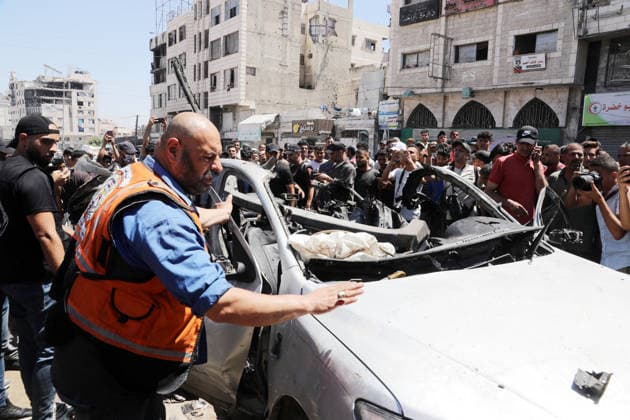 Palestinians Gather at Site of Deadly Vehicle Strike in Gaza City Palestinians and Civil Defense personnel gather around a destroyed vehicle that was targeted in an Israeli airstrike in Gaza City, on June 18, 2026. The strike killed three Palestinians, according to medical sources, and caused significant damage to the vehicle. Photo by Belal Osama apaimages Gaza Gaza Strip Palestinian Territory 180626_Gaza_BO_1_00(47) Copyright: xapaimagesxBelalxOsamax xapaimagesx