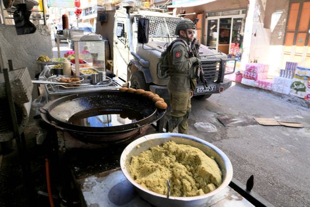 June 18, 2026, Nablus, West Bank, Palestine: Israeli soldiers are positioned in the center of the market during a raid on Balata refugee camp east of Nablus in the West Bank. Israeli forces raided the central market during a security operation. Palestinian sources said that the army arrested seven Palestinians from various neighborhoods in Nablus and its surrounding refugee camps. Nablus Palestine  - ZUMAs197 20260618_aaa_s197_006 Copyright: xNasserxishatyehx
