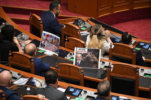 Opposition MPs in Albania block the parliamentary podium TIRANA, ALBANIA - JUNE 18: Opposition MPs unfurl banners in support of the demonstrations as session of the Albanian Parliament is interrupted several times after MPs from the main opposition party, the Democratic Party (PD), block the podium in Tirana, Albania on June 18, 2026. The agenda for the parliamentary session included a briefing by Ferit Hoxha, Minister for European and Foreign Affairs, on the country’s accession negotiations with the European Union (EU), and the discussion of several draft laws. After Parliamentary Speaker Niko Peleshi gave the floor to Minister Hoxha, PD MPs blocked the podium, demanding that the floor be given to the party’s leader, Sali Berisha. Olsi She  Copyright: x2026xAnadoluxOlsixShehux