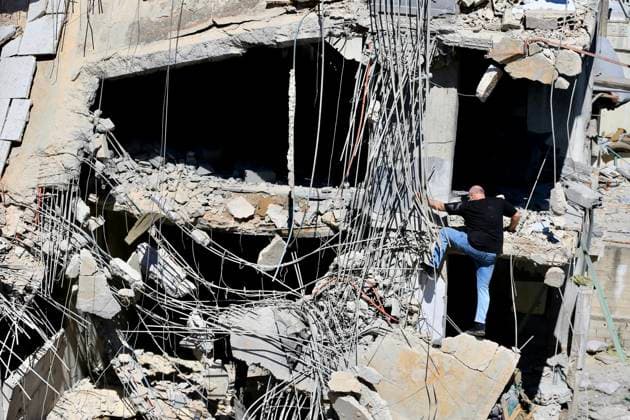 (260618) -- NABATIEH, June 18, 2026 -- Photo taken on June 18, 2026 shows a man climbing a ruined building after Israeli attacks in Nabatieh, southern Lebanon. (Photo by Xinhua) LEBANON-NABATIEH-ISRAELI ATTACKS-AFTERMATH AlixHashisho 