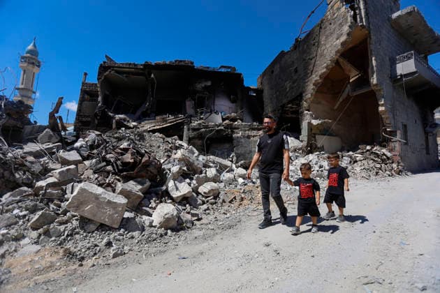 June 18, 2026, Nabatieh District, South Lebanon, lebanon: A family is seen walking through the rubble of the old souk in the city of Nabatieh, where shops and heritage buildings were heavily damaged. The scene reflects the scale of destruction in the historic marketplace, as residents navigate the remains of what was once a vibrant commercial and social hub. Nabatieh District lebanon  - ZUMAb339 20260618_znp_b339_011 Copyright: xAbdulxKaderxAlxBayx