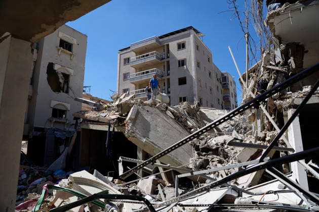 June 18, 2026, Nabatieh District, South Lebanon, lebanon: A family from the town of Kfarreman stands amid the ruins of their destroyed home, sifting through the rubble in search of personal belongings, clothes, and essential items. The scene reflects the heavy toll of recent destruction, as residents attempt to salvage what remains of their daily lives amid widespread damage. Nabatieh District lebanon  - ZUMAb339 20260618_znp_b339_013 Copyright: xAbdulxKaderxAlxBayx