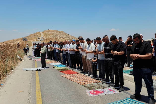 Protest Against Settlers in Dura Palestinian men perform Friday prayers on a road near a hilltop Israeli outpost in Jabal Tarousa near Dura, south of Hebron, in the occupied West Bank, on June 19, 2026. Palestinians held the prayers to protest the establishment of the newly built Israeli settlement outpost and the seizure of land. Israeli forces later fired tear gas to suppress the gathering, allegedly causing several people, including journalists, to suffer from inhalation. Dura West Bank Palestinian Territories Copyright: xMosabxShawerx