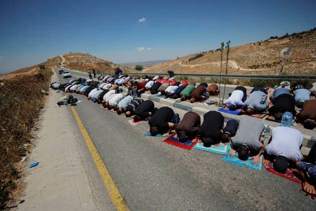 Protest Against Settlers in Dura Palestinian men perform Friday prayers on a road near a hilltop Israeli outpost in Jabal Tarousa near Dura, south of Hebron, in the occupied West Bank, on June 19, 2026. Palestinians held the prayers to protest the establishment of the newly built Israeli settlement outpost and the seizure of land. Israeli forces later fired tear gas to suppress the gathering, allegedly causing several people, including journalists, to suffer from inhalation. Dura West Bank Palestinian Territories Copyright: xMosabxShawerx