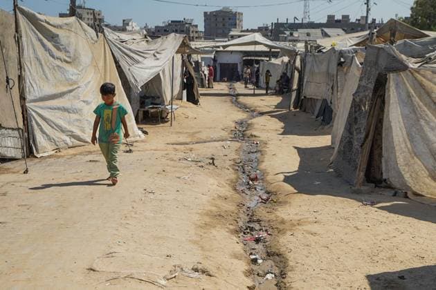 Displaced Families Endure Harsh Conditions in Bureij Refugee Camp GAZA STRIP JUNE 2026: Displaced Palestinians live in difficult conditions beside piles of accumulated waste in Bureij refugee camp. Children search through discarded materials in an attempt to find items that can help support their families amid worsening humanitarian conditions and limited access to basic necessities. BUREIJ PS Copyright: x xRamzixAbuxAmerx xJNAxPressx
