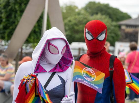 June 20, 2026, Essex, United Kingdom: Two cosplayers in red and white superhero-style costumes, one holding a rainbow flag reading Love With Pride, pose during the Essex Pride. Essex Pride is a celebration of lesbian, gay, bisexual and transgender life in Essex and beyond, led by Cheryl Hole, also known as Cheryl the Queen. Essex United Kingdom - ZUMAs197 20260620_aaa_s197_095 Copyright: xIanxDavidsonx