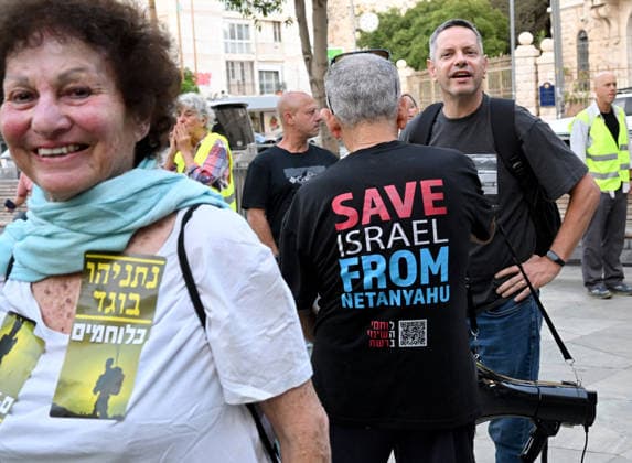 A protester wears a shirt reading Save Israel From Netanyahu at a demonstration calling on Israeli Prime Minister Benjamin Netanyahu to stop the wars in Jerusalem on Saturday, June 20, 2026. U.S. President Donald Trump has called on Prime Minister Netanyahu to stop the military strikes in Lebanon.  JER2026062013 DEBBIExHILL