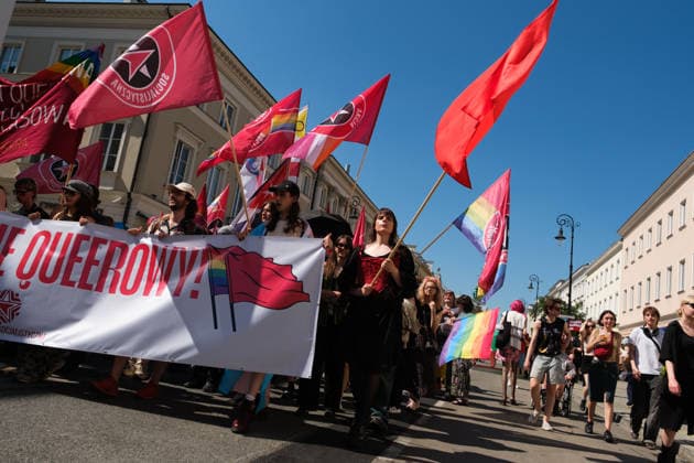 June 20, 2026, Warsaw, Masovian Voivodeship, Poland: Activists of Socialist Action carry red and rainbow flags in a socialist bloc during Warsaw s first ever radical Pride parade. Called Equality Parade - Queer Liberation March in Polish, the grassroots march was organized by a collective of radical LGBTQ+ activists as an anti-capitalist alternative to Warsaw s traditional Pride parade, which has recently become dominated by corporate sponsors. Warsaw Poland - ZUMAk204 20260620_zip_k204_008 Copyright: xRomanxKozielx