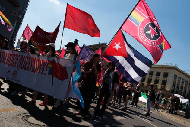 June 20, 2026, Warsaw, Masovian Voivodeship, Poland: Activists of Socialist Action carry red and rainbow flags along with a flag of Cuba in a socialist bloc during Warsaw s first ever radical Pride parade. Called Equality Parade - Queer Liberation March in Polish, the grassroots march was organized by a collective of radical LGBTQ+ activists as an anti-capitalist alternative to Warsaw s traditional Pride parade, which has recently become dominated by corporate sponsors. Warsaw Poland - ZUMAk204 20260620_zip_k204_017 Copyright: xRomanxKozielx
