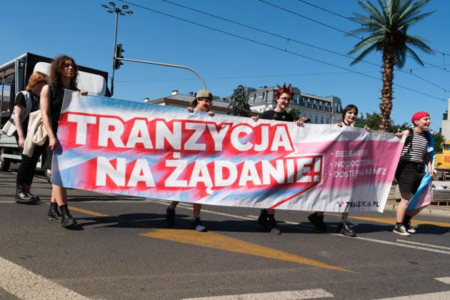 June 20, 2026, Warsaw, Masovian Voivodeship, Poland: Trans activists carry a large banner that reads transition on demand - without barriers, modern, available through the public health service during Warsaw s first ever radical Pride parade. Called Equality Parade - Queer Liberation March in Polish, the grassroots march was organized by a collective of radical LGBTQ+ activists as an anti-capitalist alternative to Warsaw s traditional Pride parade, which has recently become dominated by corporate sponsors. Warsaw Poland - ZUMAk204 20260620_zip_k204_018 Copyright: xRomanxKozielx