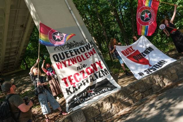 June 20, 2026, Warsaw, Masovian Voivodeship, Poland: Activists wave Socialist Action red-rainbow flags and display two banners that read queer liberation, not rainbow capitalism (left) and strike a blow against the system with your queerness (right) during Warsaw s first ever radical Pride parade. Called Equality Parade - Queer Liberation March in Polish, the grassroots march was organized by a collective of radical LGBTQ+ activists as an anti-capitalist alternative to Warsaw s traditional Pride parade, which has recently become dominated by corporate sponsors. Warsaw Poland - ZUMAk204 20260620_zip_k204_021 Copyright: xRomanxKozielx