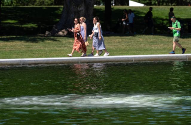 Hydrogen Peroxide is pumped into the newly renovated Lincoln Memorial Reflecting Pool to clean algae as residents and tourists walk by on the National Mall in Washington, DC on Saturday, June 20,2026. The Trump Administration awarded no-bid contracts totaling nearly $15 million to renovated Reflecting Pool but it is now filled with algae and the paint is peeling. Dozens of National Guard and other police stop people from taking the blue paint chips floating in the water, with some arrests.  WAP20260620151 PATxBENIC