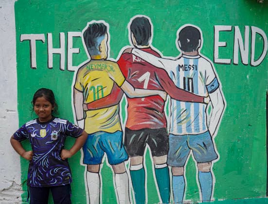 June 21, 2026, Chittagong, Chittagong, Bangladesh: Children gather around FIFA World Cup 2026-themed murals, posing with footballs, reenacting iconic celebrations and mimicking their favourite players. Painted on the walls of a residential neighbourhood, the murals have become a focal point for local youngsters, reflecting how football fever reaches beyond the pitch and brings communities together through shared passion and play. Chittagong Bangladesh - ZUMAs356 20260621_zip_s356_003 Copyright: xMohammedxSumanx