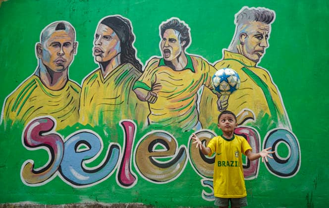 June 21, 2026, Chittagong, Chittagong, Bangladesh: Children gather around FIFA World Cup 2026-themed murals, posing with footballs, reenacting iconic celebrations and mimicking their favourite players. Painted on the walls of a residential neighbourhood, the murals have become a focal point for local youngsters, reflecting how football fever reaches beyond the pitch and brings communities together through shared passion and play. Chittagong Bangladesh - ZUMAs356 20260621_zip_s356_006 Copyright: xMohammedxSumanx