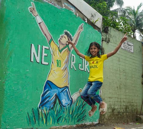 June 21, 2026, Chittagong, Chittagong, Bangladesh: Children gather around FIFA World Cup 2026-themed murals, posing with footballs, reenacting iconic celebrations and mimicking their favourite players. Painted on the walls of a residential neighbourhood, the murals have become a focal point for local youngsters, reflecting how football fever reaches beyond the pitch and brings communities together through shared passion and play. Chittagong Bangladesh - ZUMAs356 20260621_zip_s356_013 Copyright: xMohammedxSumanx
