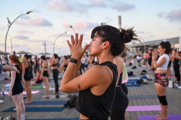 June 21, 2026, Tel-Aviv, Tel-Aviv, Israel: Hundreds of participants practice yoga during International Yoga Day at the Tel Aviv Port in Tel Aviv, joining an open public session featuring 108 Sun Salutations (Surya Namaskar), a traditional sequence symbolizing mindfulness, endurance and gratitude. Tel-Aviv Israel - ZUMAp227 20260621_zip_p227_018 Copyright: xPaulinaxPatimerx