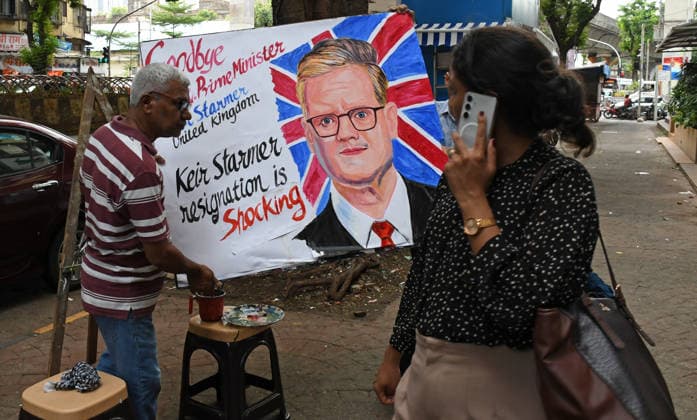 June 22, 2026, Mumbai, Maharashtra, India: A teacher from Gurukul school of art carry back a painted poster with a message bidding goodbye and shocked by resignation of United Kingdom Prime Minister Keir Starmer outside their art school. United Kingdom Prime Minister Keir Starmer announced his resignation acknowledging that the Labour s Parliamentary Party he inherited doesn t see him as the best candidate to lead them into the next general election bringing another short chapter to an end in the turbulent period of British politics. Mumbai India - ZUMAs197 20260622_aaa_s197_087 Copyright: xAshishxVaishnavx