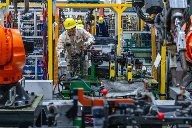 JINHUA, CHINA - JUNE 22: An employee works on the production line at the workshop of new energy vehicle components enterprise on June 22, 2026 in Jinhua, Zhejiang Province of China.  Copyright: xVCGx 111649698786