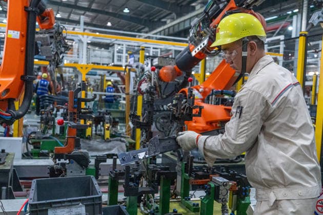 JINHUA, CHINA - JUNE 22: An employee works on the production line at the workshop of new energy vehicle components enterprise on June 22, 2026 in Jinhua, Zhejiang Province of China.  Copyright: xVCGx 111649698787