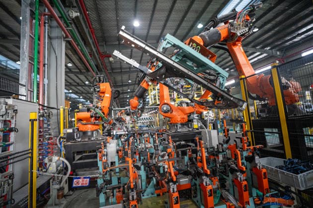 JINHUA, CHINA - JUNE 22: Industrial robots work on the production line at the workshop of new energy vehicle components enterprise on June 22, 2026 in Jinhua, Zhejiang Province of China.  Copyright: xVCGx 111649698776