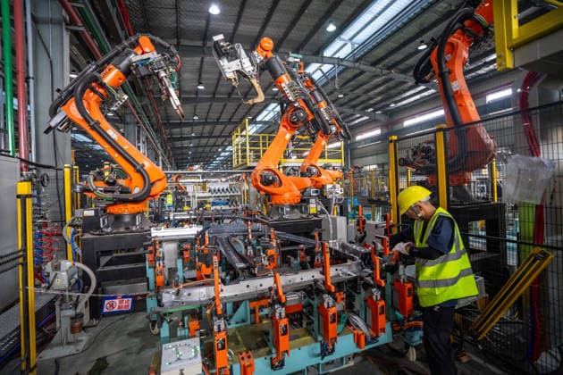 JINHUA, CHINA - JUNE 22: Industrial robots work on the production line at the workshop of new energy vehicle components enterprise on June 22, 2026 in Jinhua, Zhejiang Province of China.  Copyright: xVCGx 111649698777