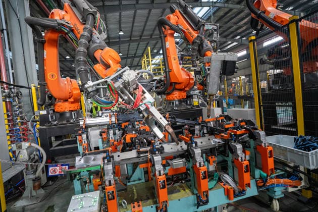JINHUA, CHINA - JUNE 22: Industrial robots work on the production line at the workshop of new energy vehicle components enterprise on June 22, 2026 in Jinhua, Zhejiang Province of China.  Copyright: xVCGx 111649698779