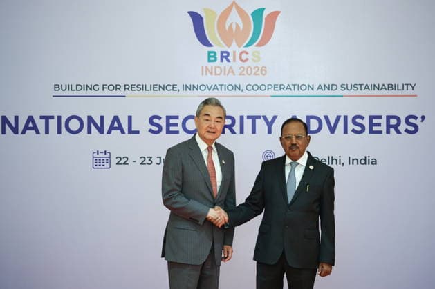 INDIA, NEW DELHI - JUNE 23, 2026: China s Foreign Minister Wang Yi (L) and Ajit Doval, National Security Advisor to the Prime Minister of India, shake hands during a welcoming ceremony as part of the BRICS National Security Advisers Meeting. Mikhail Tereshchenko TASS  94168657