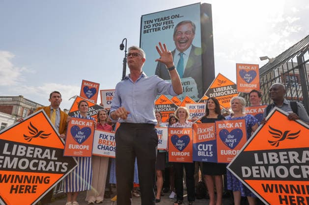 June 23, 2026, London, London, UK: London, UK. Dr Al Pinkerton, Liberal Democrat MP for Surrey Heath, addresses party MPs and activists in front of a digital billboard in Fulham, London, during the launch of the party s new national campaign targeting Reform UK leader Nigel Farage and highlighting a Â£5 million gift he received, as the party marks the 10th anniversary of the Brexit referendum with the launch of its nationwide billboard campaign. London UK  - ZUMAl94_ 20260623_zaf_l94_018 Copyright: xDinendraxHariax