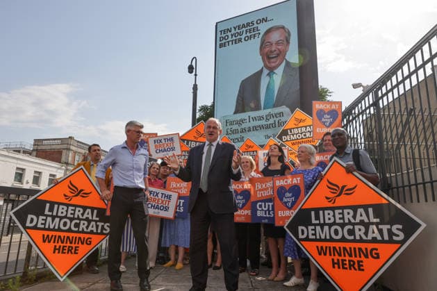 June 23, 2026, London, London, UK: London, UK. Liberal Democrat leader Ed Davey addresses party MPs and activists in front of a digital billboard in Fulham, London, during the launch of a new national campaign targeting Reform UK leader Nigel Farage and highlighting a Â£5 million gift he received, as the party marks the 10th anniversary of the Brexit referendum with the launch of its nationwide billboard campaign. London UK  - ZUMAl94_ 20260623_zaf_l94_020 Copyright: xDinendraxHariax