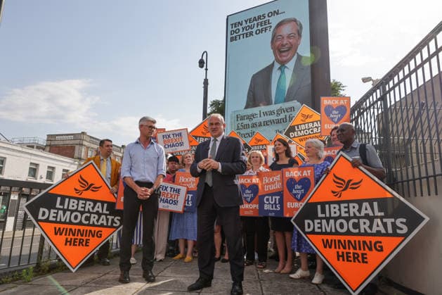 June 23, 2026, London, London, UK: London, UK. Liberal Democrat leader Ed Davey addresses party MPs and activists in front of a digital billboard in Fulham, London, during the launch of a new national campaign targeting Reform UK leader Nigel Farage and highlighting a Â£5 million gift he received, as the party marks the 10th anniversary of the Brexit referendum with the launch of its nationwide billboard campaign. London UK  - ZUMAl94_ 20260623_zaf_l94_021 Copyright: xDinendraxHariax