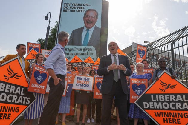 June 23, 2026, London, London, UK: London, UK. Liberal Democrat leader Ed Davey addresses party MPs and activists in front of a digital billboard in Fulham, London, during the launch of a new national campaign targeting Reform UK leader Nigel Farage and highlighting a Â£5 million gift he received, as the party marks the 10th anniversary of the Brexit referendum with the launch of its nationwide billboard campaign. London UK  - ZUMAl94_ 20260623_zaf_l94_023 Copyright: xDinendraxHariax