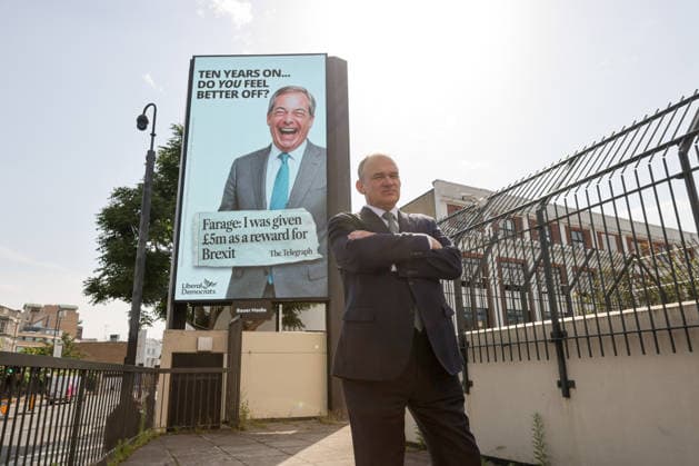 June 23, 2026, London, London, UK: London, UK. Liberal Democrat leader Ed Davey poses in front of a digital billboard in Fulham, London, during the launch of the Liberal Democrats new national campaign targeting Reform UK leader Nigel Farage and highlighting a Â£5 million gift he received, as the party marks the 10th anniversary of the Brexit referendum. London UK  - ZUMAl94_ 20260623_zaf_l94_032 Copyright: xDinendraxHariax