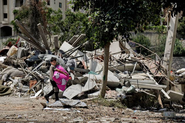 June 23, 2026, Nabatieh, Nabatieh, Lebanon: Lebanese boy Haidar Shawa, carries belongings he was able to salvage with his mother from their house, demolished in an Israeli air strike in the southern Lebanese Nabatieh al-Fawqa neighborhood. Scores of Lebanese who fled their villages started to return to face a devastating shock of finding their homes completely demolished. Following the recent US-Iran deal, residents have attempted to return, only to be met with scenes of rubble and ash. Nabatieh Lebanon - ZUMAn313 20260623_zip_n313_007 Copyright: xMarwanxNaamanix
