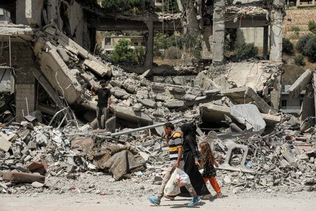 June 23, 2026, Nabatieh, Nabatieh, Lebanon: A Lebanese family walk past rubble of destroyed building caused by Israeli air strikes in the southern Lebanese Nabatieh al-Fawqa neighborhood. Scores of Lebanese who fled their villages started to return to face a devastating shock of finding their homes completely demolished. Following the recent US-Iran deal, residents have attempted to return, only to be met with scenes of rubble and ash. Nabatieh Lebanon - ZUMAn313 20260623_zip_n313_017 Copyright: xMarwanxNaamanix