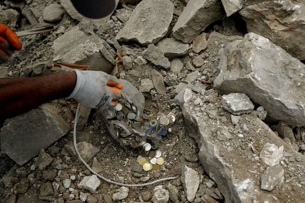 June 23, 2026, Mayfadoun, Mayfadoun, Lebanon: A man salvages a piggy bank from between the rubble of his house in the devastated southern Lebanese village of Mayfadoun. Scores of Lebanese who fled their villages started to return to face a devastating shock of finding their homes completely demolished. Following the recent US-Iran deal, residents have attempted to return, only to be met with scenes of rubble and ash. Mayfadoun Lebanon - ZUMAn313 20260623_zip_n313_020 Copyright: xMarwanxNaamanix