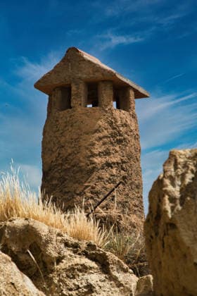 Creative Highlights World #2 Rustic earthen chimney tower against a blue sky Guadix, Andalusia, Spain R_CCZG260618-2056398-01