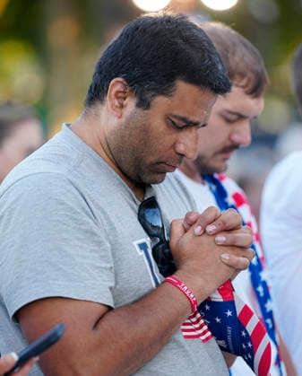 Attendees bow their heads in prayer before President Donald Trump speaks at a rally to kick off the 16-day Great American State Fair as part of Washington, D.C. s celebration of the nation s 250th birthday on the National Mall on Wednesday, June 24, 2026. The rally will include military flyovers, musical performances from Lee Greenwood and Christopher Macchio, and the U.S. Army Band, the U.S. Marine Band and Armed Forces choirs.  WAP20260624350 BONNIExCASH