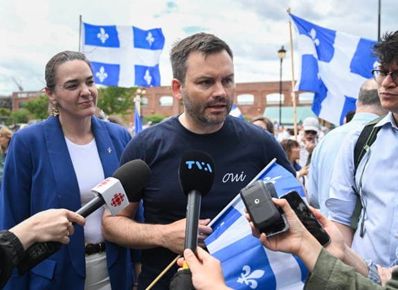 June 24, 2026, Montreal, Pq, Canada: Parti Quebecois leader Paul St-Pierre Plamondon, centre, speaks to the media as he attends the Saint-Jean-Baptiste Day parade in Montreal, on Wednesday, June 24, 2026. Montreal Canada  - ZUMAc35_ 20260624_zaf_c35_183 Copyright: xGrahamxHughesx