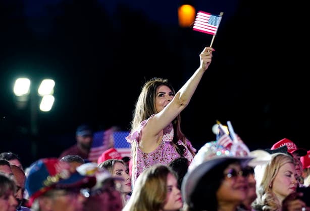 Attendees hold American Flags as President Donald Trump speaks at a rally to kick off the 16-day Great American State Fair as part of Washington, D.C. s celebration of the nation s 250th birthday on the National Mall on Wednesday, June 24, 2026. The rally will include military flyovers, musical performances from Lee Greenwood and Christopher Macchio, and the U.S. Army Band, the U.S. Marine Band and Armed Forces choirs.  WAP202606244056 BONNIExCASH