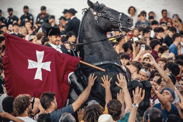 June 24, 2026, Ciutadella, Menorca Balearic Islands, Spain: A caixer (horse rider) rears up on his horse surrounded by a cheering crowd during the cargol prior to the Jocs des Pla (medieval tournament) during the traditional Sant Joan (Saint John) festival in Ciutadella de Menorca Ciutadella Spain - ZUMAo105 20260624_fap_o105_025 Copyright: xMatthiasxOesterlex
