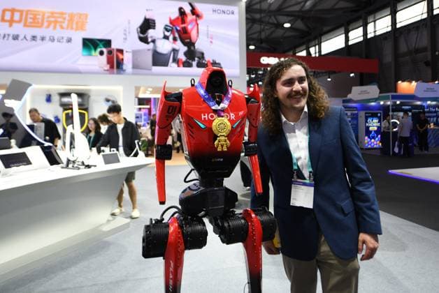 MWC2026 in Shanghai SHANGHAI, CHINA - JUNE 25, 2026 - A foreign audience takes a photo with an Honor humanoid robot at MWC 226 in Shanghai, China on June 25, 2026. Shanghai Shanghai China  Copyright: xCFOTOx i1782397695374