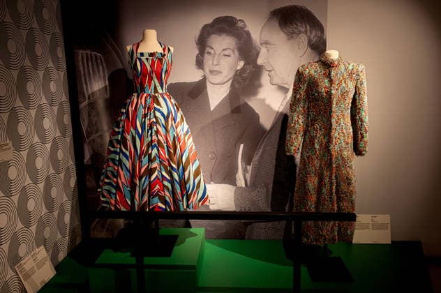 Exhibition: Fashion in Light 1955 1975 ROME, ITALY - JUNE 25: Cocktail Dress, Sorelle Fontana, circa 1953, in printed cotton and tarlatan with polychrome abstract patterns in shades of coral red, light and dark blue, pink, brown and white, (L), Capotto by Laura Biagiotti , circa 1972, long coat in fur-stitch knit, characterized by a multicolored palette in shades of turquoise, orange and purple. (R) during the Exhibition Fashion in Light 1955 1975, Rome: between glamour and industrial innovation, featuring cinema, style, the great fashion designers, timeless brands, and the stars of the silver screen and haute couture, at the Capitoline Museums, Centrale Montemartini on June 25, 2026 in Rome, Italy. Rome Italy Copyright: xStefanoxMontesix