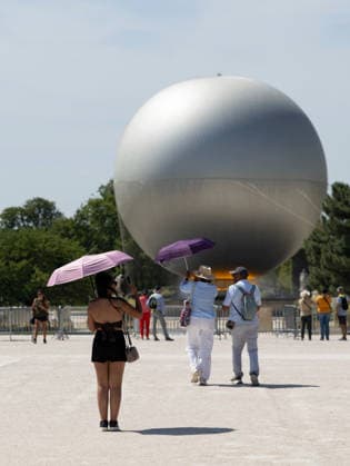 (260625) -- PARIS, June 25, 2026 -- Visitors walk in front of the Paris 2024 Olympic cauldron near the Louvre Museum amid the heatwave, in Paris, France, June 25, 2026. ) FRANCE-PARIS-HEATWAVE WuxHuiwo 