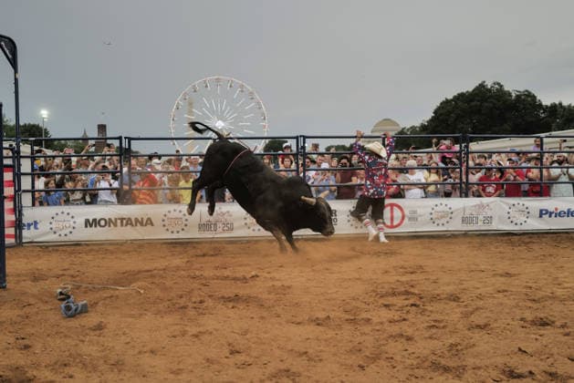 June 26, 2026, Washington, District Of Columbia, USA: A rodeo worker runs from a bucking bull at a rodeo during the Great American State Fair on the National Mall in Washington, D.C. on June 26, 2026. Rodeo 250, produced by Cervi Rodeo Company, is one of numerous events during the 16-day fair, celebrating the 250th anniversary of the United States of America. Washington USA - ZUMAd227 20260626_znp_d227_053 Copyright: xBryanxDozierx